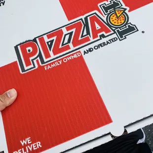 a hand holding a pizza box