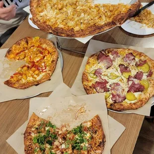 Buffalo chicken pizza, bbq chicken pizza with hot honey drizzle, The Heartless and their new special (pastrami pizza)