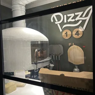 a view of a pizza oven through a window