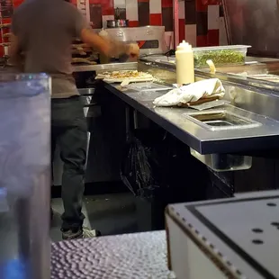 Pizza guy making pizza with unclean hands and no gloves