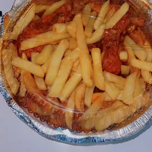 Buffalo Wings under all the fries. I don&apos;t mind my fries with Buffalo sauce now. This is how it&apos;s served. Mmm