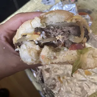 Cheeseburger with extra Grilled Onions. I couldn&apos;t resist taking a bite. So Good!