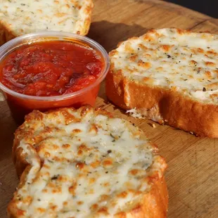 four slices of bread with cheese and tomato sauce