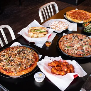 a table full of different pizzas