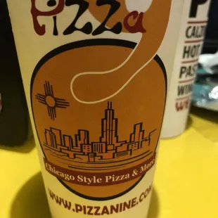 a cup of pizza on a table