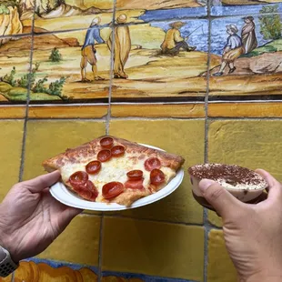 Hand painted tile in the small outdoor eating area to the left of pick up window. Pepperoni pizza and tiramisu