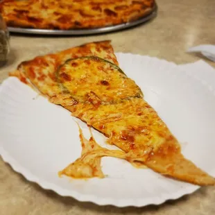 a slice of cheese pizza on a paper plate