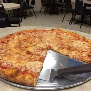 a cheese pizza with a slice taken out of it