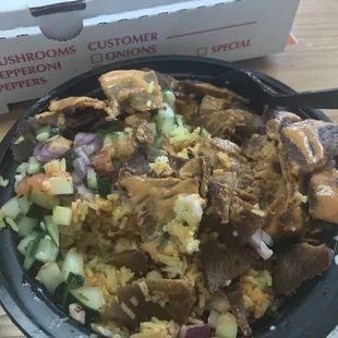 Rice bowl with lamb/beef stirred a little, the other ingredients under the meat and spicy sauce