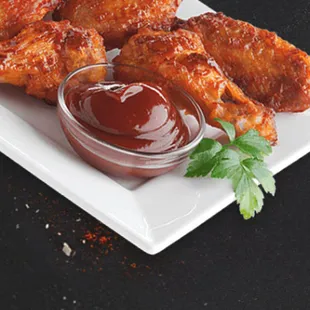  plate of chicken wings with ketchup