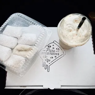 a box of doughnuts and a cup of coffee