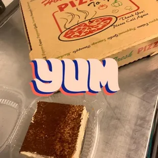 a box of pizza and a slice of cake