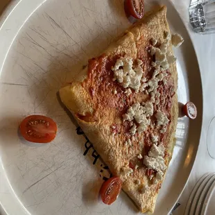 a slice of pizza on a plate