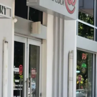 the entrance to a pizza place