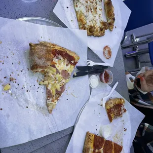 Pizza by the slice Hawaiian and pepperoni with cheesy bread