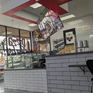 a pizza parlor with a neon sign