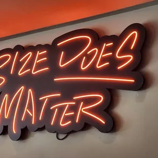 a neon sign that says size does matter