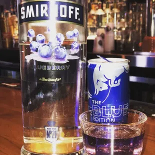 a bottle of smir diff and a shot of blueberries