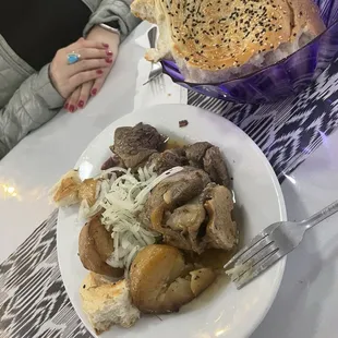 Lamb, potatoes, bread. I have no idea what this is called. They showed me a picture and I ordered it!