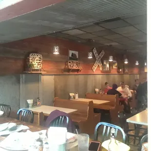 Big bar table for large group, booths in back, rustic decor.