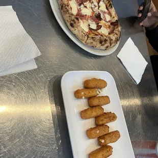 a plate of deep dish pizza and appetizers