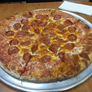 pepperoni and cheese on a pizza pan