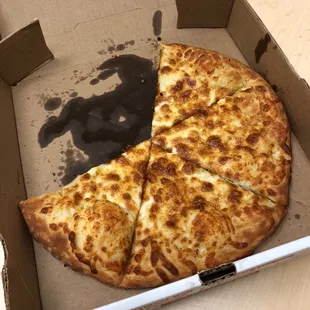 a half eaten pizza in a box