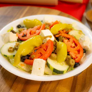 Greek Salad: our house salad toped with feta cheese, black and green olives with 3 pepperoncinis