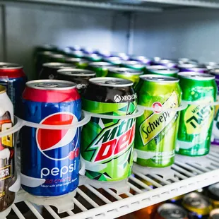 a variety of sodas in a refrigerator