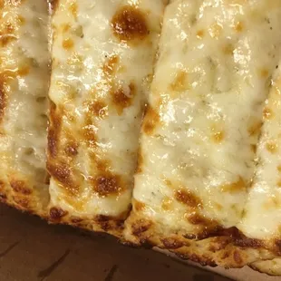 four slices of cheese pizza in a box