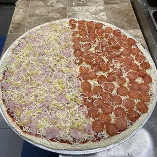 pepperoni, ham, and cheese on a pizza pan