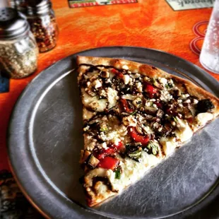 a slice of pizza on a plate