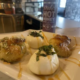 three appetizers on a white plate