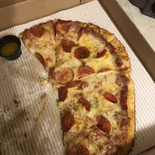 a slice of pepperoni pizza in a box