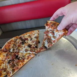 A sausage, bacon, and mushroom pizza