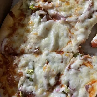 Small pizza with red onions and green pepper comes with cut of butter and spices to pour over