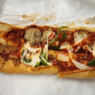 a slice of pizza with meatballs and peppers