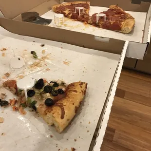 a slice of pizza left in a box