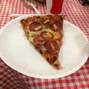 a slice of pizza on a paper plate