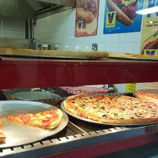pizzas in a display case