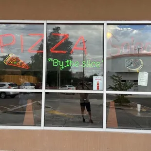 Pizza Castle.  Window with neon signs.