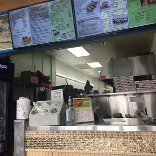 menus on the wall above the counter