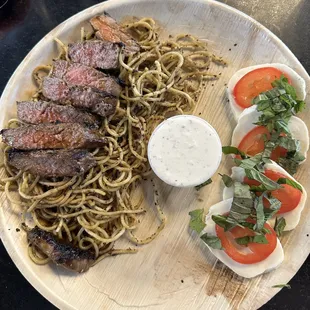 Marinated NY Strip and Caprese -Served over Garlic Noodles, w/ Scratch Steak Sauce, Horseradish Sauce &amp; a Caprese Salad w/ Balsamic Dressing