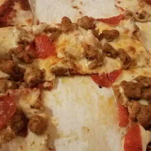 Sausage pepperoni pizza,  thin crust, pretty good. Generous meat toppings,  so I appreciate that