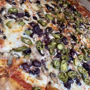 Extra large pizza with mushrooms olives jalapeños