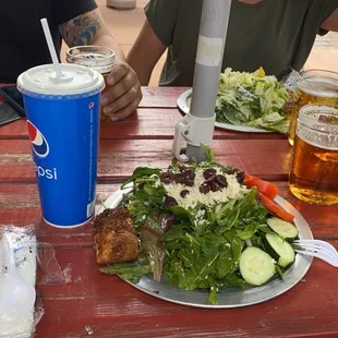 a plate of salad and a drink