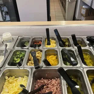 a variety of toppings in trays