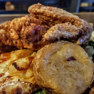 a plate of fried chicken and potatoes