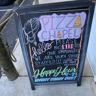 a chalkboard sign on a sidewalk