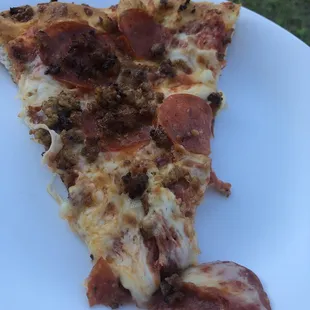 a slice of pizza on a plate